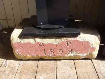 YOU CAN SEE THIE FOUNDATION STONE OF THE CHURCH AT THE RIGHT SIDE OF THE ENTRANCE TO THE COFFEE SHOP